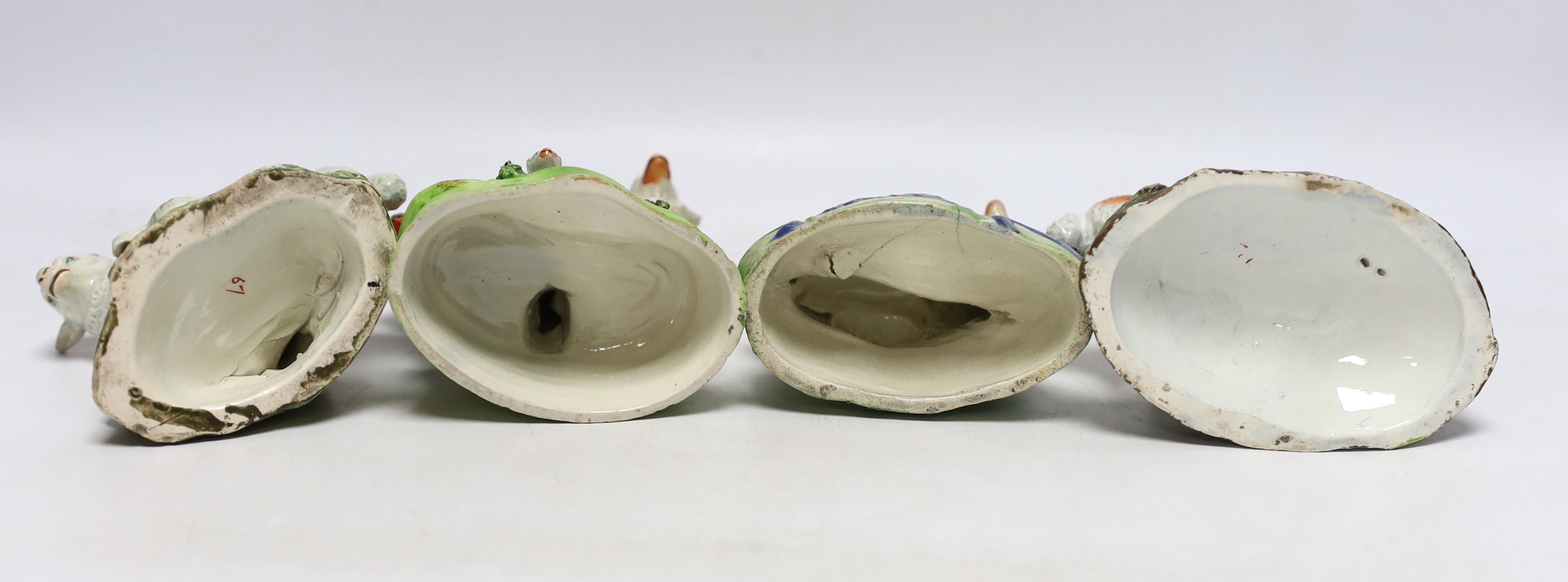 Four Staffordshire pearlware figures of sheep, c.1820-30, one with rare initials ‘PW’ to its back, largest 15cm high